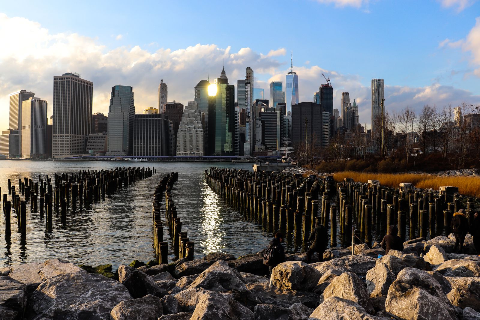 Stunning view of New York City skyline from the waterfront with old piers in foreground.