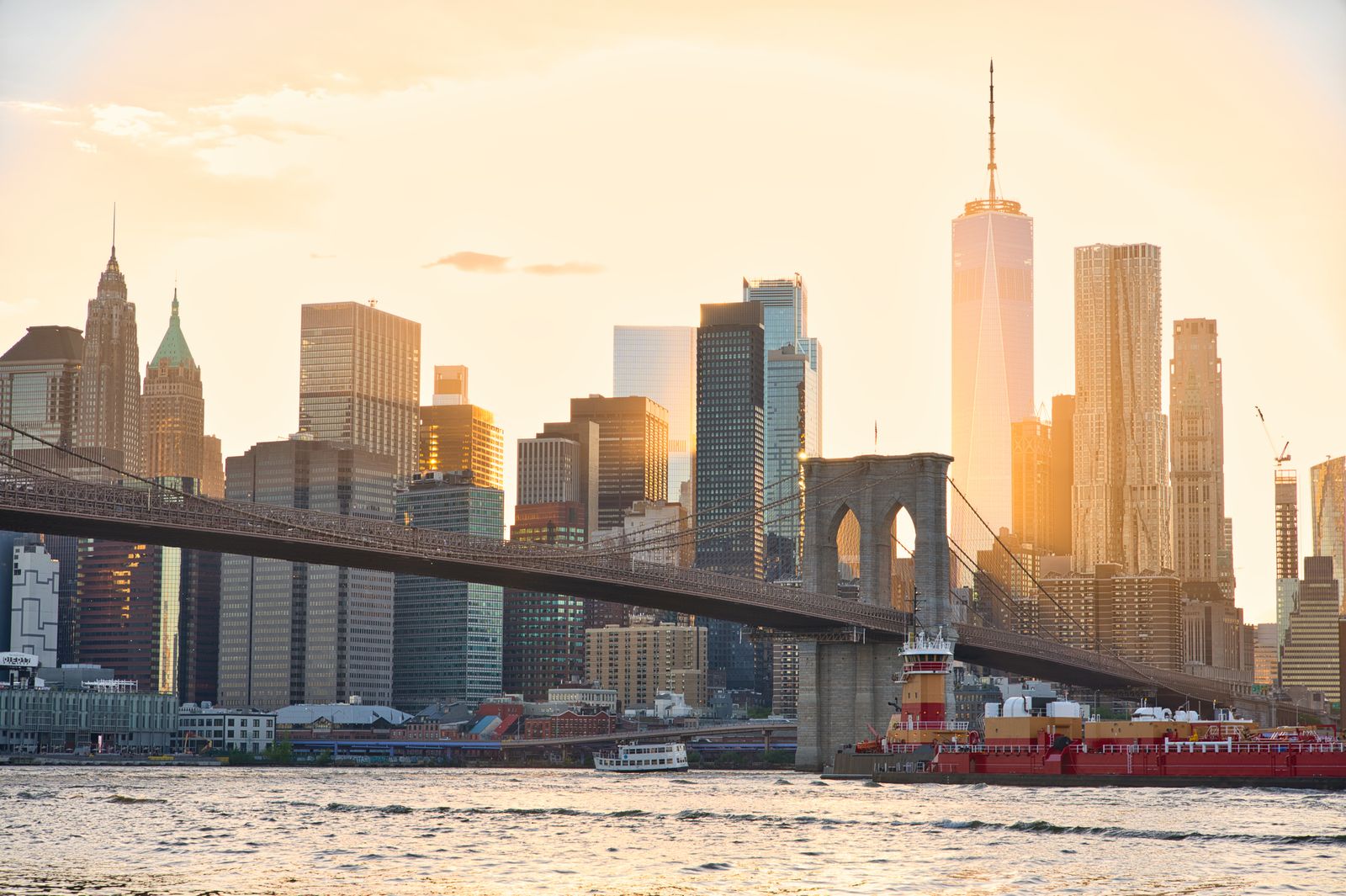 A stunning view of the Brooklyn Bridge and New York City's skyline at sunset.